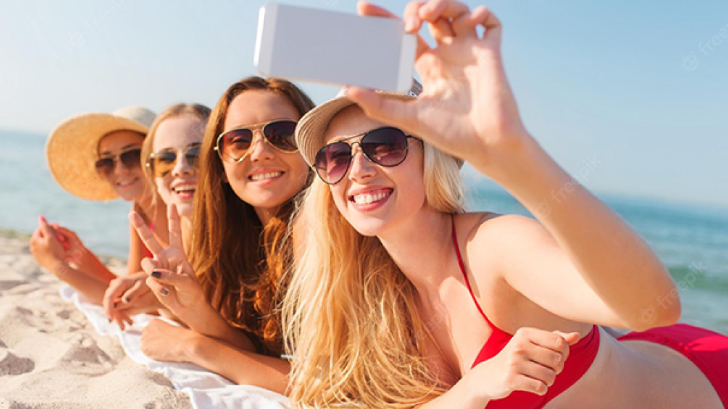 summer-vacation-travel-technology-people-concept-group-smiling-women-sunglasses-making-selfie-with-smartphone-beach_380164-72238